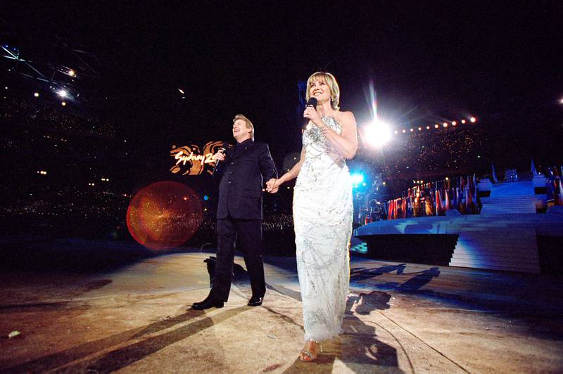 John Farnham and Olivia Newton-John sing during the Opening Ceremony of the Sydney 2000 Olympic Games at the Olympic Stadium in Homebush Bay, Sydney, Australia. Mandatory Credit: Jed Jacobsohn /Allsport