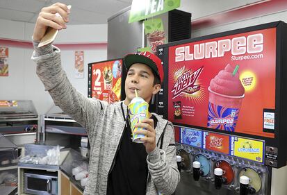 Singer Austin Mahone enjoys a Slurpee in Boca Raton, Florida. (Photo by Larry Marano/Getty Images for 7-Eleven)