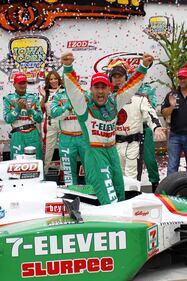 Tony Kanaan of Brazil, representing 7-Eleven, celebrates in victory lane at the IRL Indycar Series Iowa Corn Indy 250 in 2010 in Newton, Iowa.  (Photo by Chris Trotman/Getty Images)