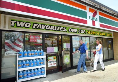 Customers walks towards the entrance to a 7-Eleven store in Des Plaines, Illinois. Dallas(Photo by Tim Boyle/Getty Images)