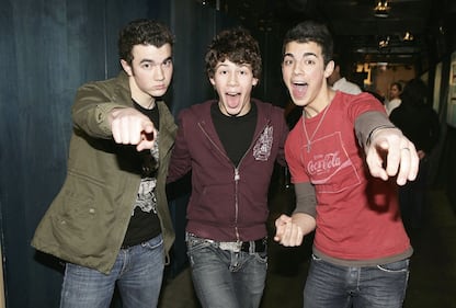 March 1, 2006: Kevin, Nick, and Joe Jonas of The Jonas Brothers pose for a photo backstage during an event in Times Square.