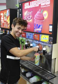Alex Constancio enjoys a slurpee at a 7-Eleven in Boca Raton, Florida.  (Photo by Larry Marano/Getty Images for 7-Eleven)