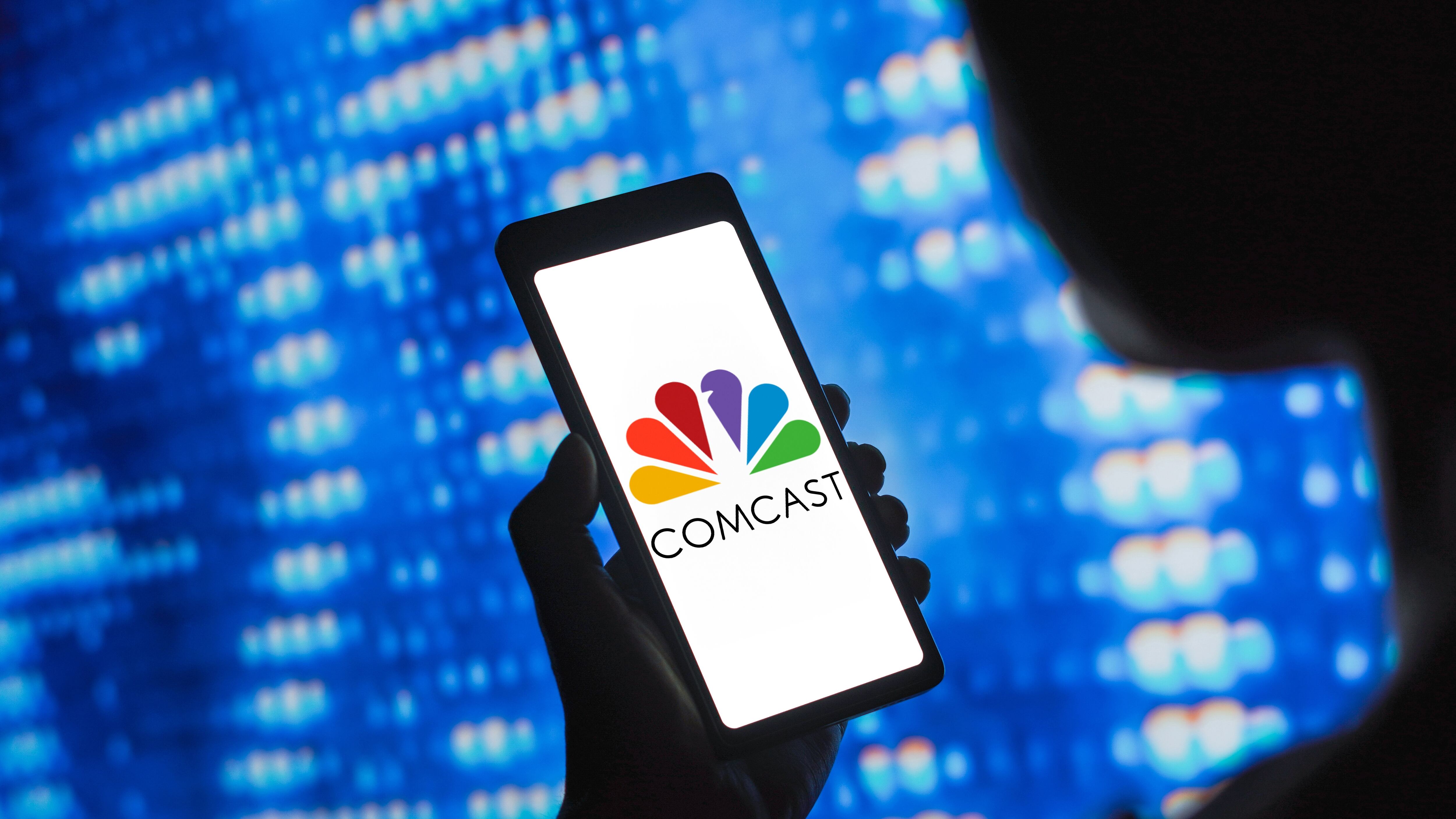 Comcast Corporation logo is displayed on a smartphone screen