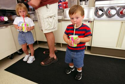 These two Florida natives are observing 7-Eleven's 75th anniversary in 2002.  (Photo by Joe Raedle/Getty Images)